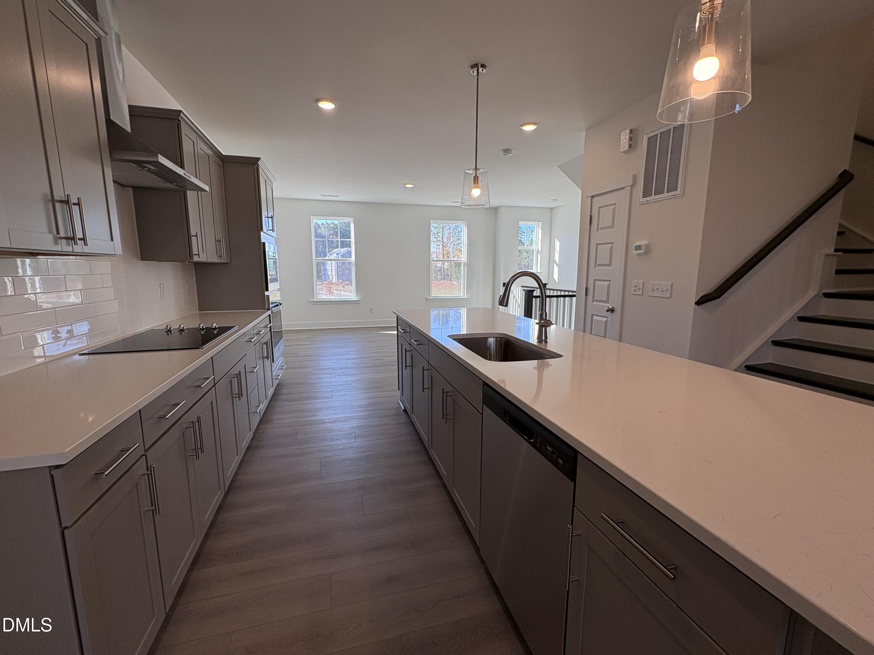 6046 Dunzo Drive Raleigh, NC 27617 - Photo 6 of 44 a kitchen with counter top space cabinets and stainless steel appliances