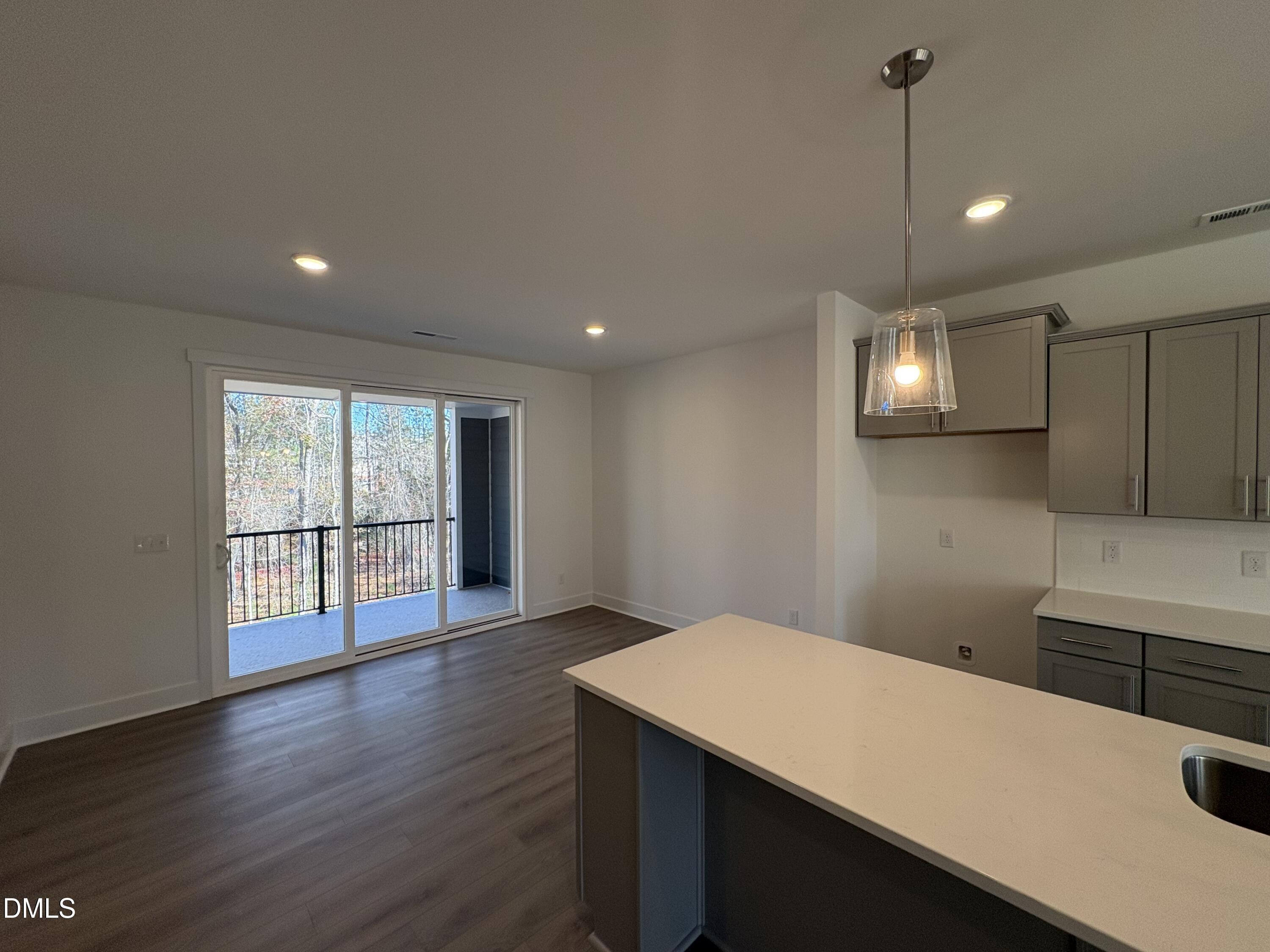 6046 Dunzo Drive Raleigh, NC 27617 - Photo 7 of 44 a view of kitchen with a sink wooden floor and windows
