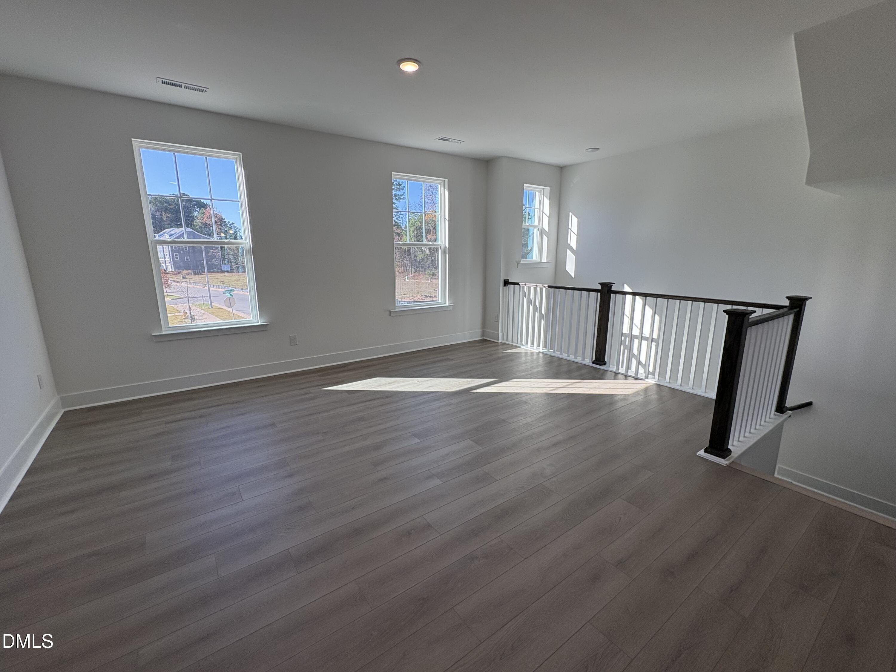 6046 Dunzo Drive Raleigh, NC 27617 - Photo 10 of 44 a view of an empty room with wooden floor and window