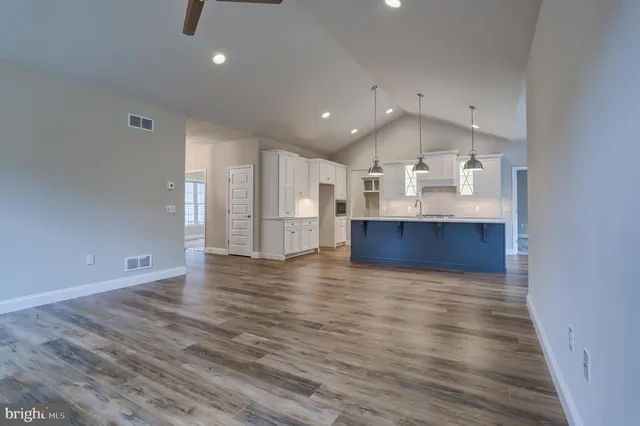 a view of kitchen and hall with wooden floor
