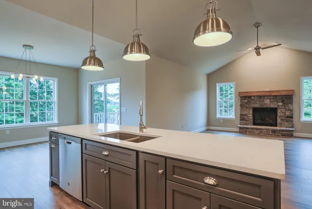 a kitchen with a sink a chandelier and a fireplace