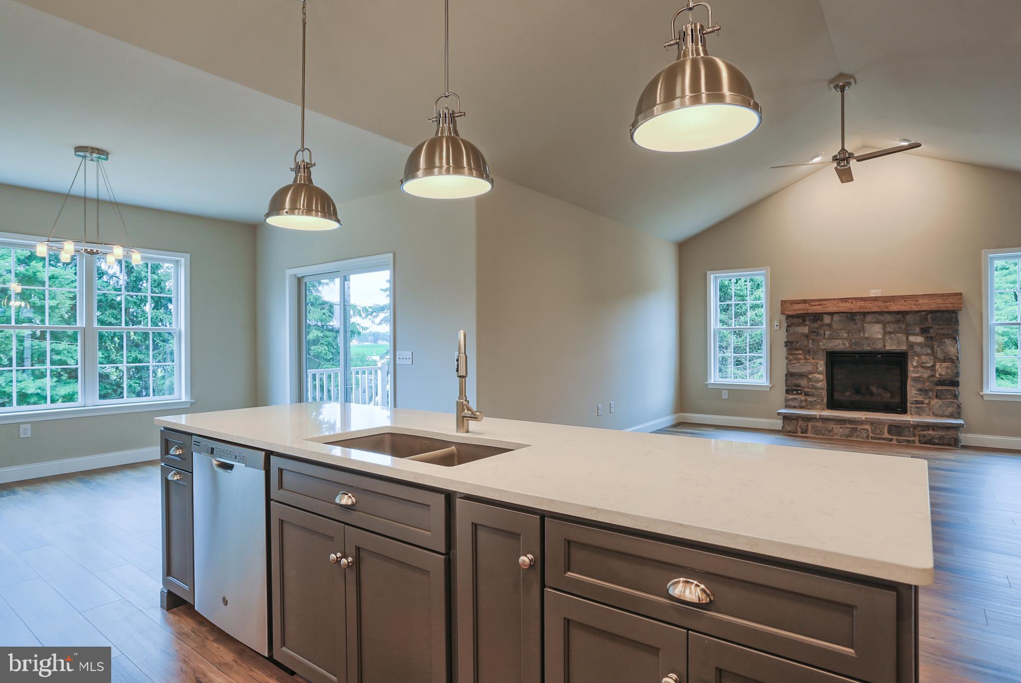 111 Starlight Lane Lebanon, PA 17046 - Photo 17 of 30 a kitchen with a sink a chandelier and a fireplace