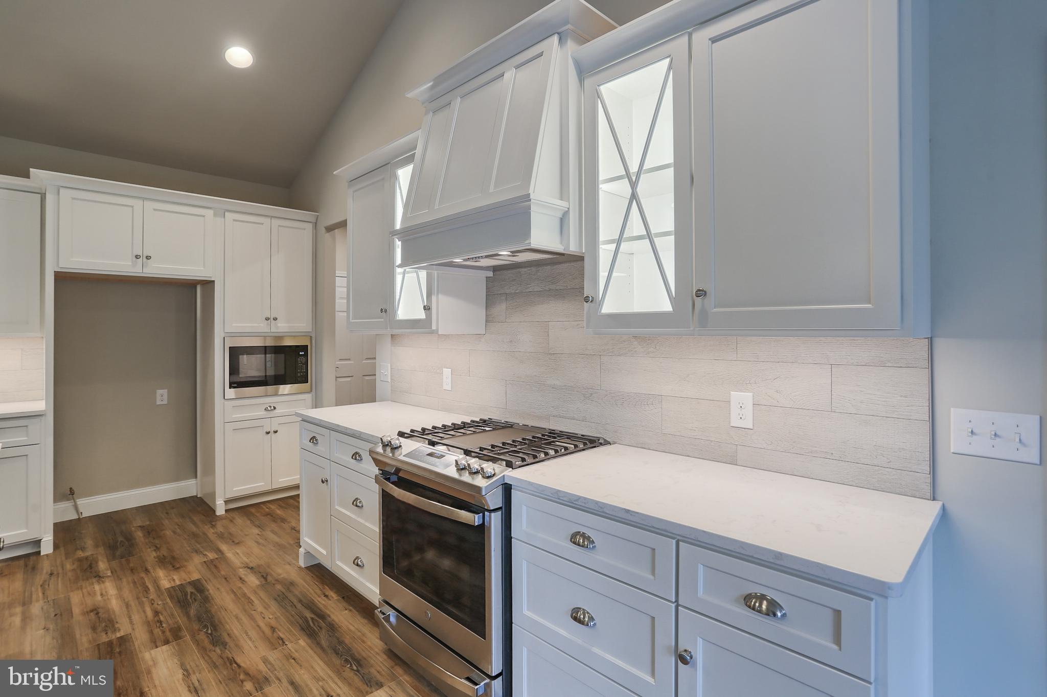 111 Starlight Lane Lebanon, PA 17046 - Photo 19 of 30 a kitchen with granite countertop a stove a sink dishwasher and a refrigerator with wooden floor