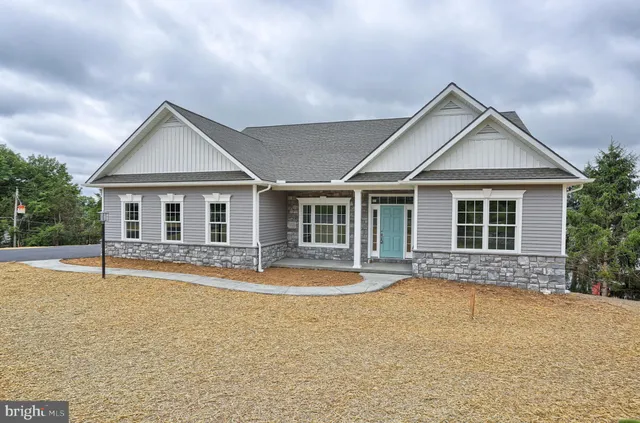 a front view of a house with a yard and outdoor seating