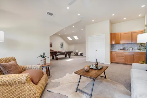 a living room with furniture and kitchen view