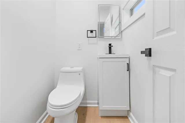 a white toilet sitting next to a bathroom sink