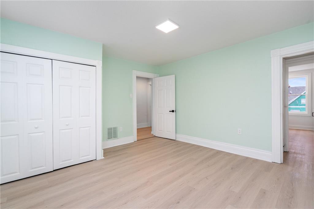 67 Ruth Street Pittsburgh, PA 15211 - Photo 12 of 26 an empty room with wooden floor and closet