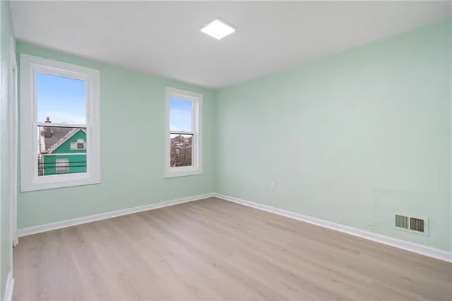 an empty room with wooden floor