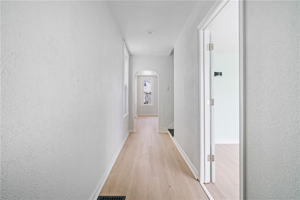 67 Ruth Street Pittsburgh, PA 15211 - Photo 2 of 26 a view of a hallway with wooden floor