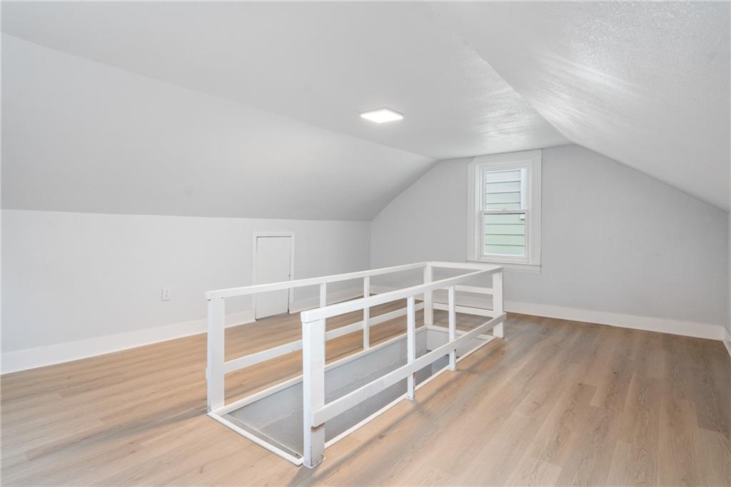 67 Ruth Street Pittsburgh, PA 15211 - Photo 21 of 26 a view of an empty room with wooden floor and a window