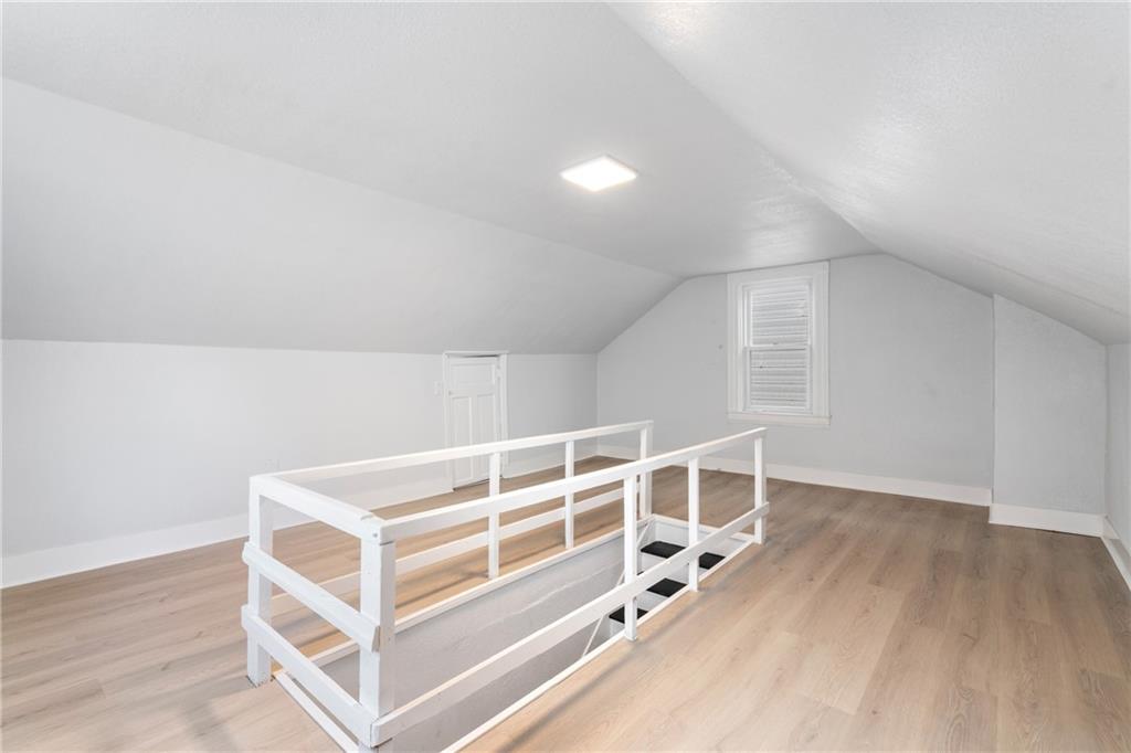 67 Ruth Street Pittsburgh, PA 15211 - Photo 22 of 26 an empty room with wooden floor and windows