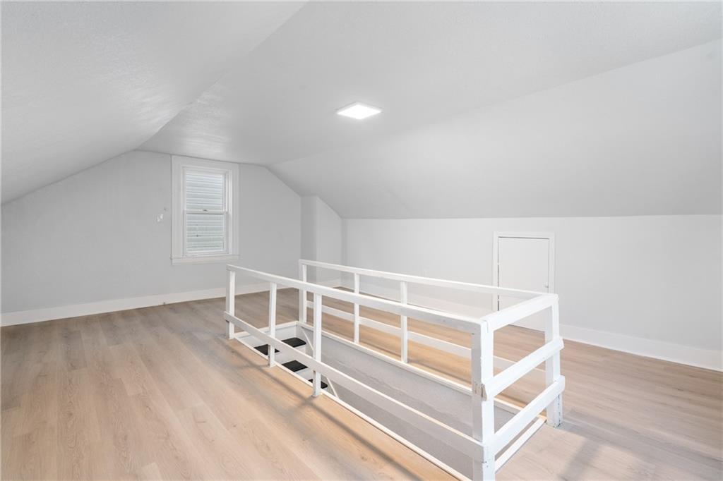 67 Ruth Street Pittsburgh, PA 15211 - Photo 23 of 26 an empty room with wooden floor and windows