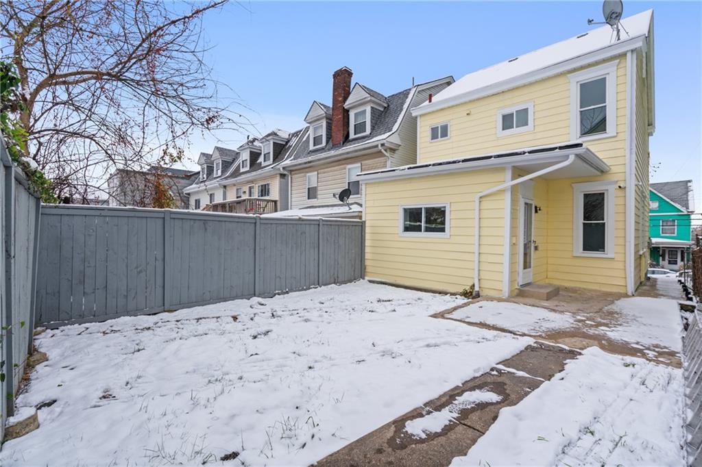 67 Ruth Street Pittsburgh, PA 15211 - Photo 24 of 26 a front view of a house with a snow on the road