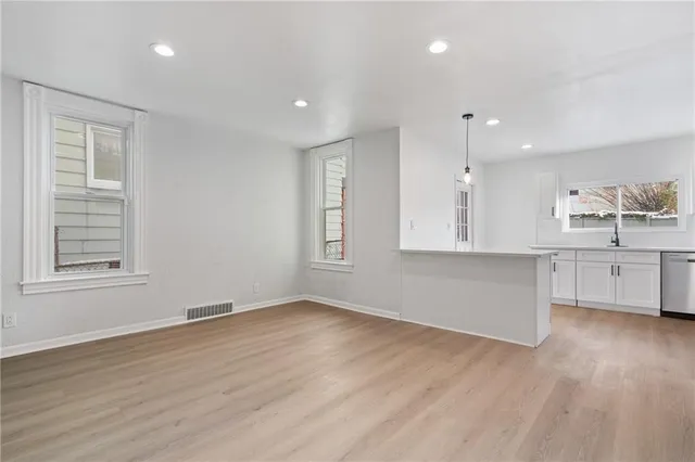 a view of kitchen with wooden floor and windows