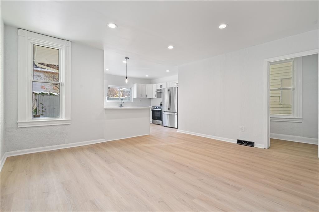 67 Ruth Street Pittsburgh, PA 15211 - Photo 9 of 26 a view of an empty room with window and wooden floor