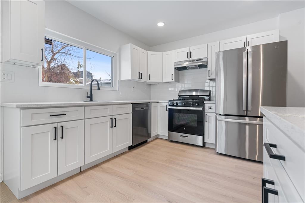 67 Ruth Street Pittsburgh, PA 15211 - Photo 10 of 26 a kitchen with a refrigerator a sink and wooden floor