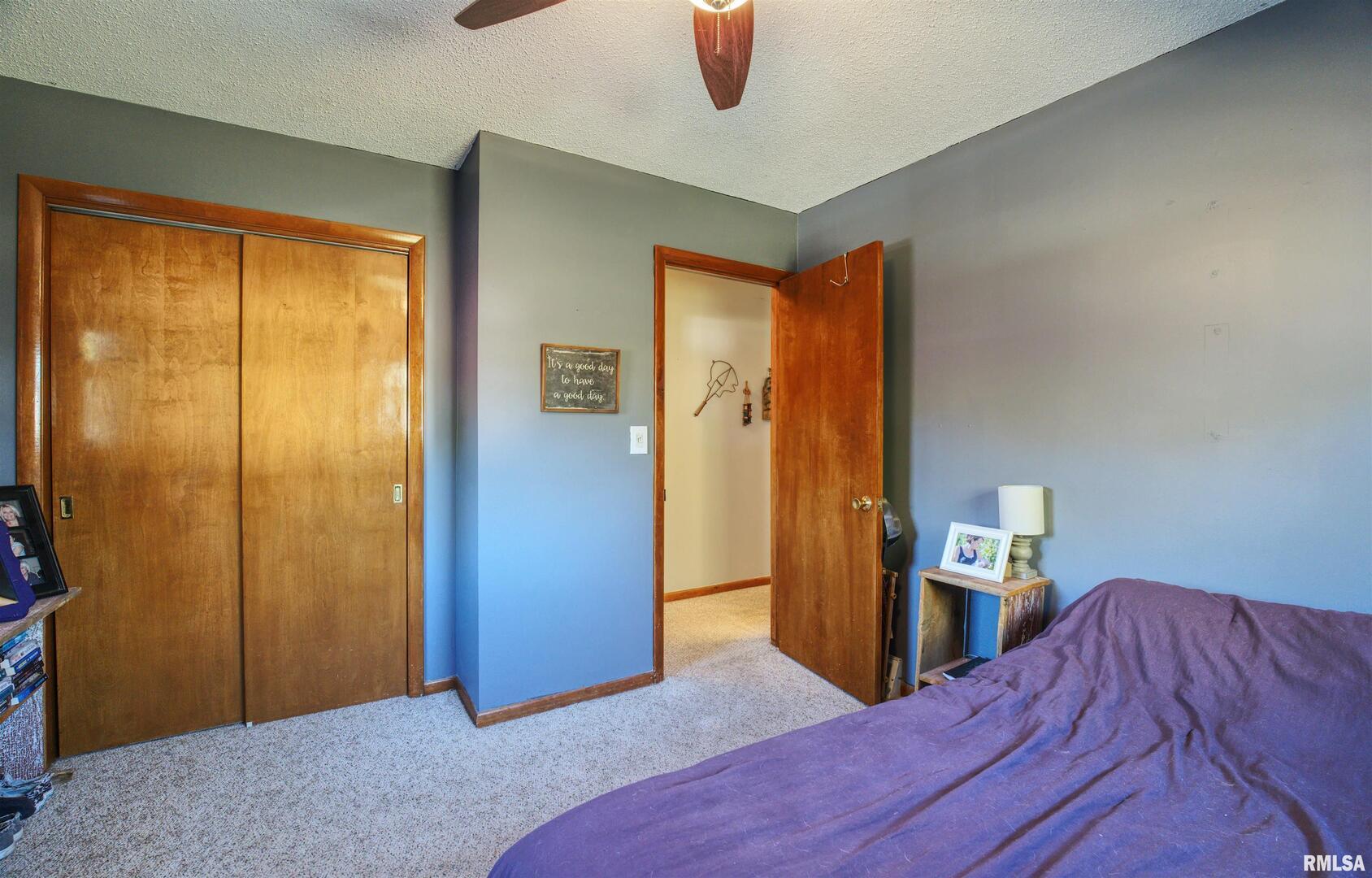 872 5th Avenue North Clinton, IA 52732 - Photo 11 of 19 a bedroom with a bed and wooden floor