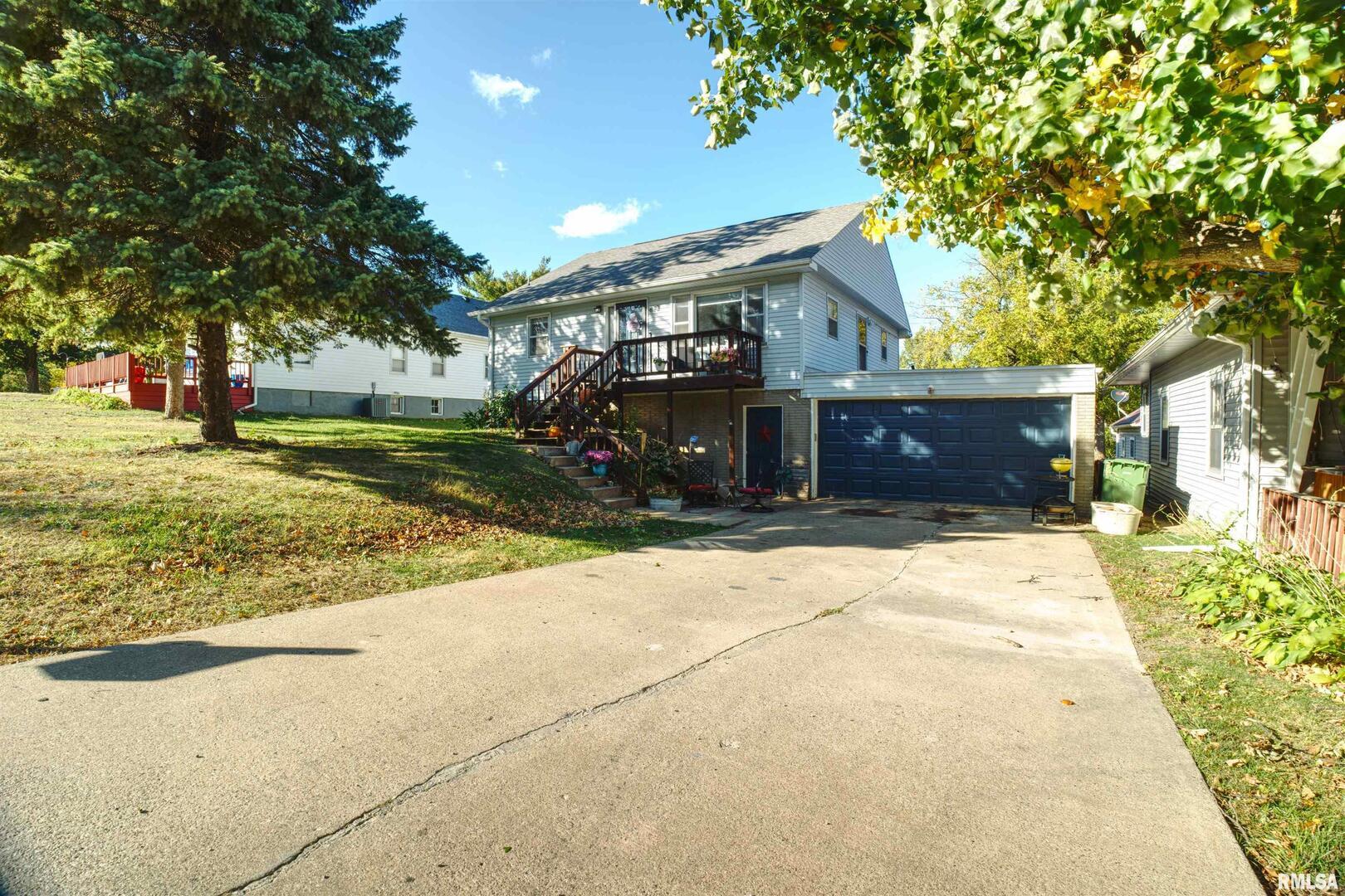 872 5th Avenue North Clinton, IA 52732 - Photo 3 of 19 a front view of a house with a yard and garage