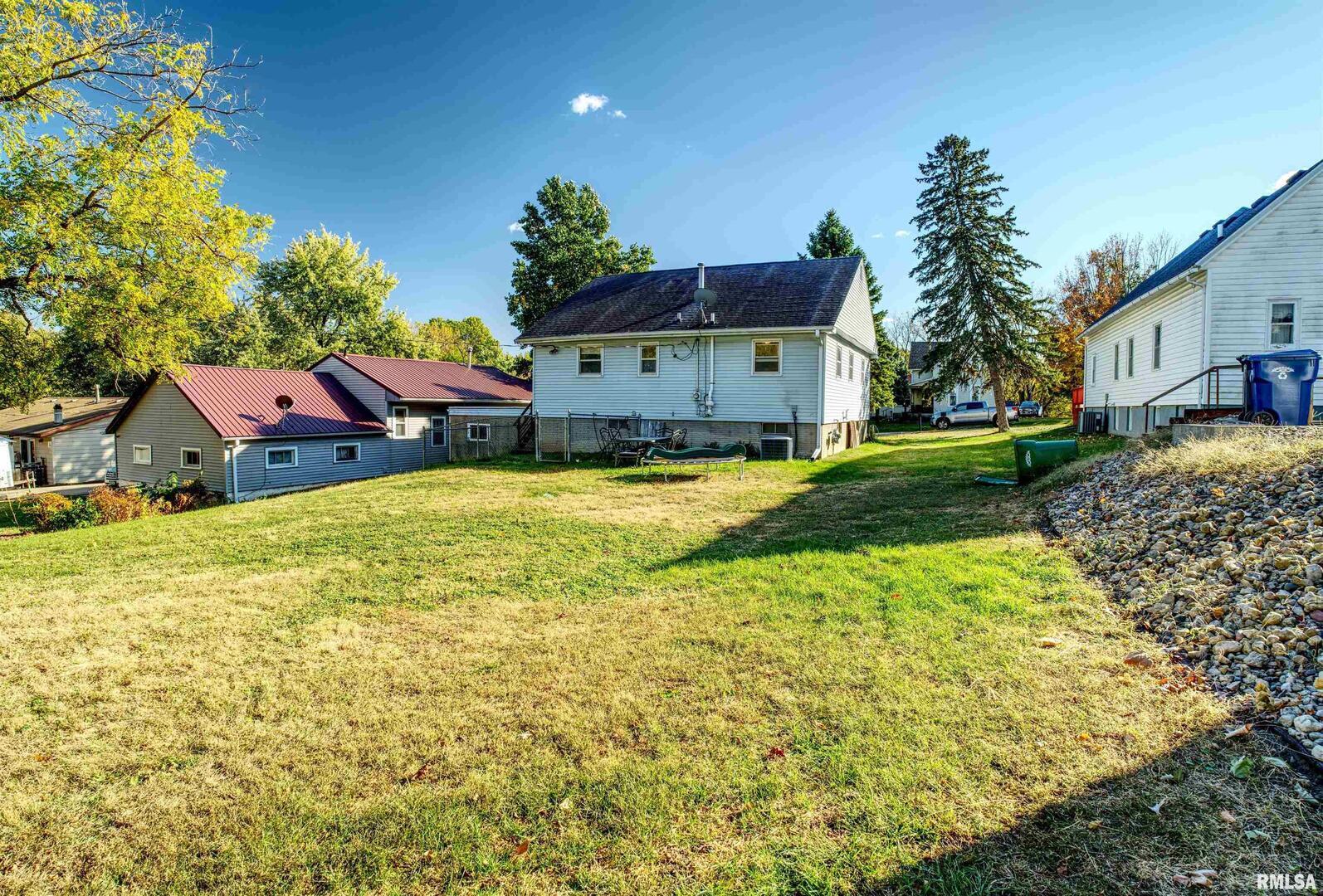 872 5th Avenue North Clinton, IA 52732 - Photo 5 of 19 a view of a house with a big yard and large trees