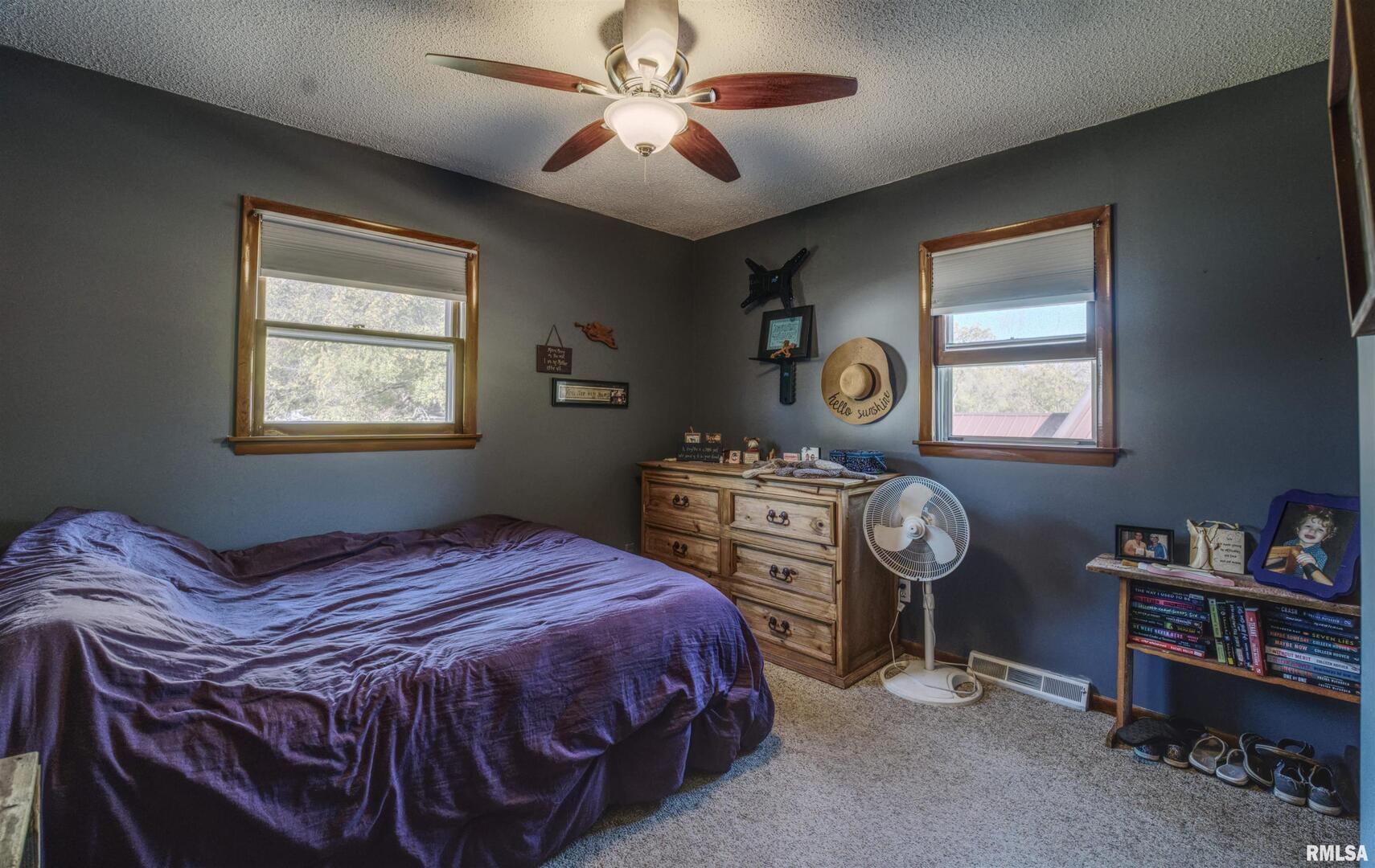 872 5th Avenue North Clinton, IA 52732 - Photo 9 of 19 a bedroom with a bed and a chandelier