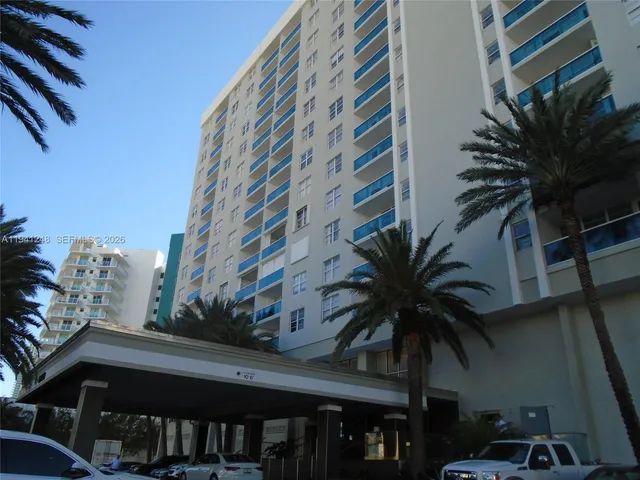 a couple of cars parked in front of building