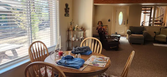 a bedroom with a bed next to a window