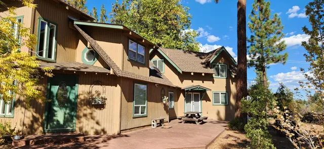 a view of a house with a tree in the background