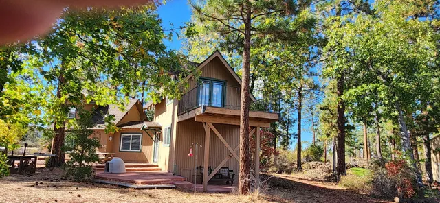 a front view of a house with trees