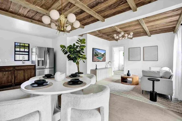 a view of a dining room with furniture and chandelier