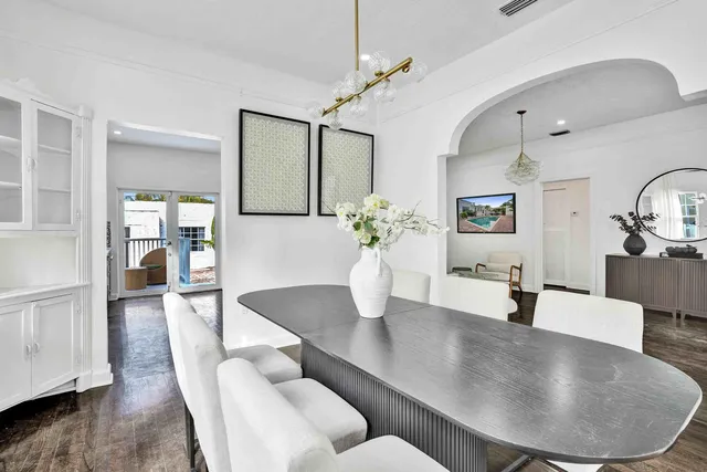 a dining room with furniture and wooden floor