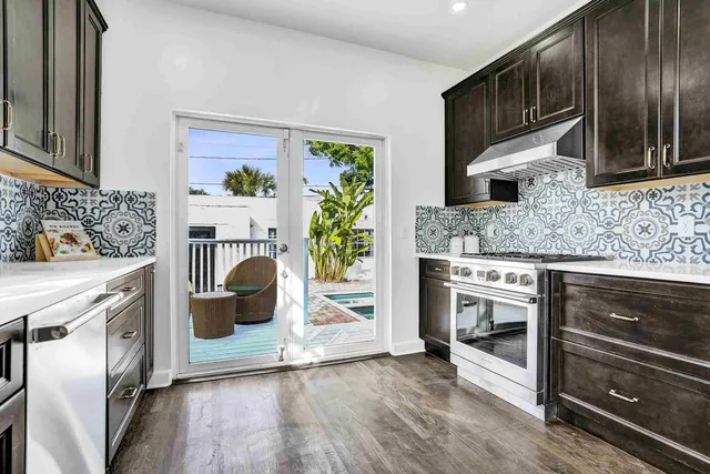 a kitchen with granite countertop a stove and a refrigerator