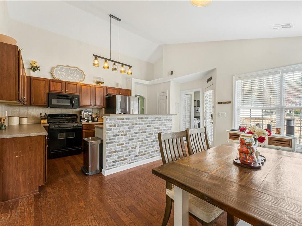 301 Summerstone Court Canton, GA 30114 - Photo 12 of 31 a kitchen with stainless steel appliances kitchen island granite countertop a stove a kitchen island a dining table and chairs
