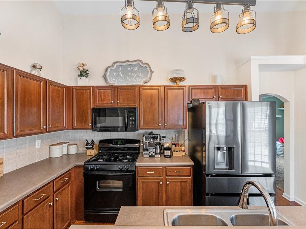 301 Summerstone Court Canton, GA 30114 - Photo 14 of 31 a kitchen with stainless steel appliances a stove a refrigerator a sink and a stove