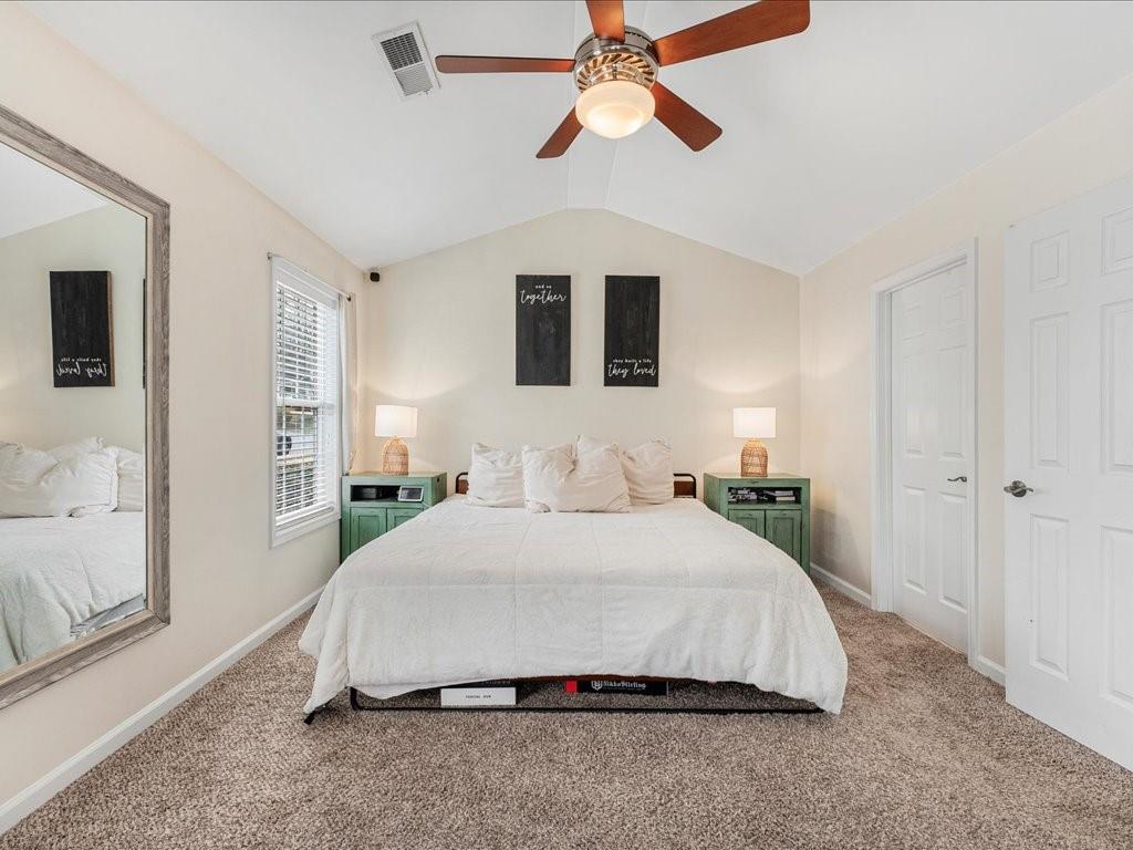 301 Summerstone Court Canton, GA 30114 - Photo 15 of 31 a bedroom with a large bed and a chandelier