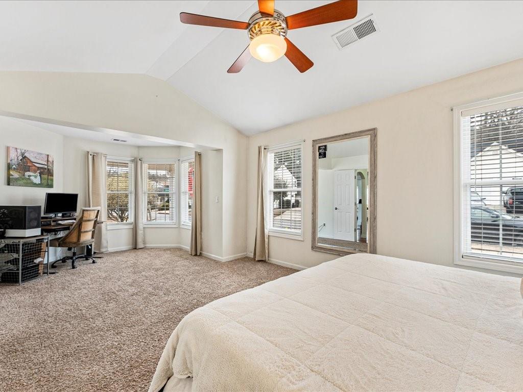301 Summerstone Court Canton, GA 30114 - Photo 19 of 31 a spacious bedroom with a bed and a chandelier