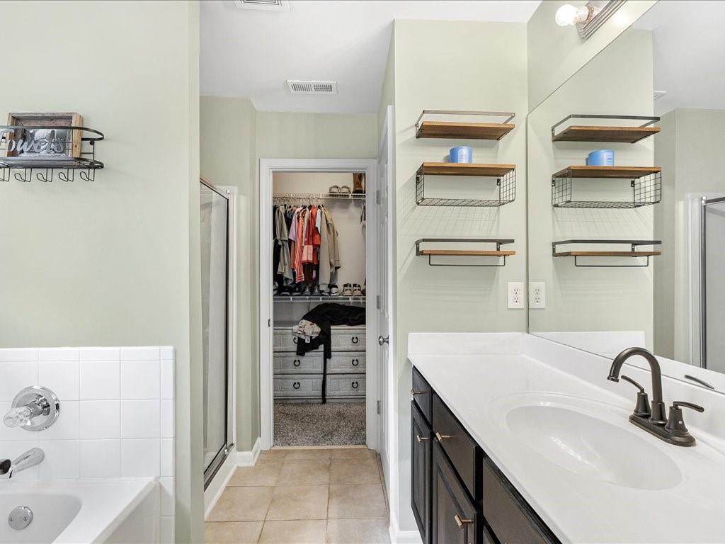 301 Summerstone Court Canton, GA 30114 - Photo 20 of 31 a en suite bathroom with a sink and a tub