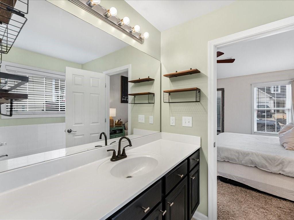301 Summerstone Court Canton, GA 30114 - Photo 21 of 31 a en suite bathroom with a sink double vanity and a tub