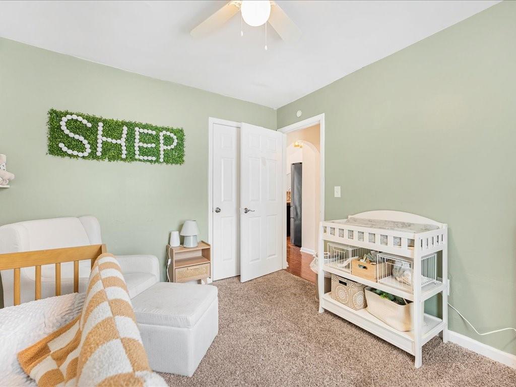 301 Summerstone Court Canton, GA 30114 - Photo 25 of 31 a bedroom with a bed and a chandelier