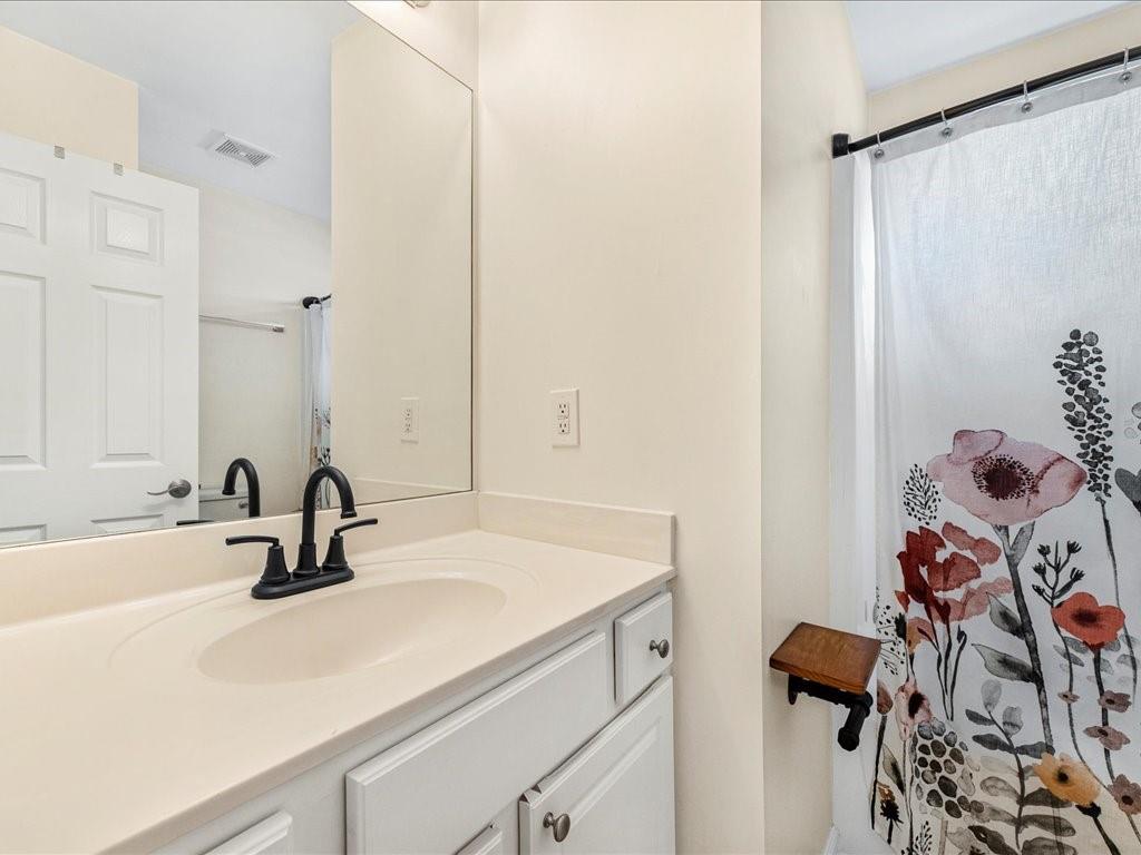 301 Summerstone Court Canton, GA 30114 - Photo 26 of 31 a bathroom with a sink and a mirror