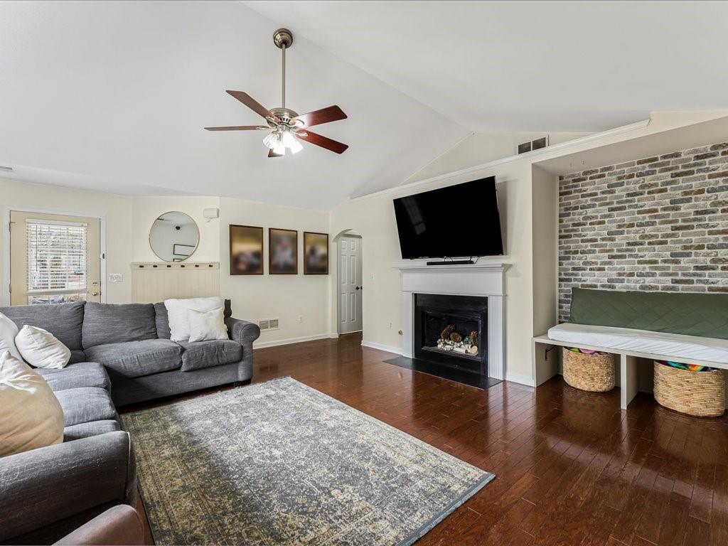 301 Summerstone Court Canton, GA 30114 - Photo 9 of 31 a living room with furniture a fireplace and a flat screen tv