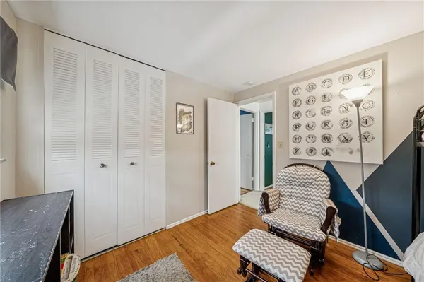a bedroom with a bed chandelier and a window