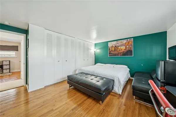 a bedroom with furniture and a flat screen tv