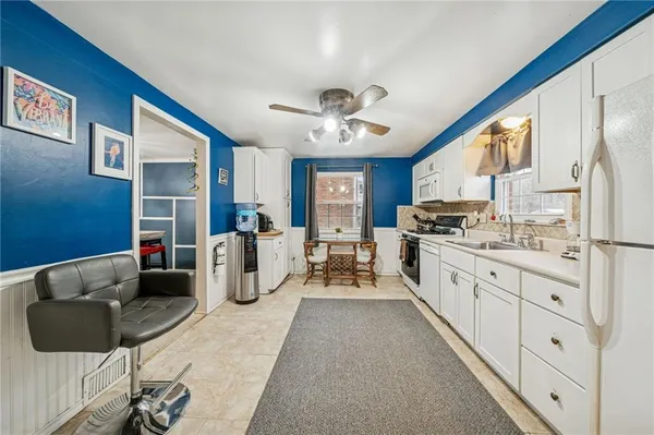 a kitchen with cabinets a sink and appliances