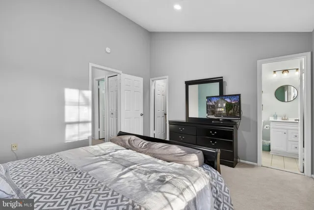 a living room with furniture a flat screen tv and a window