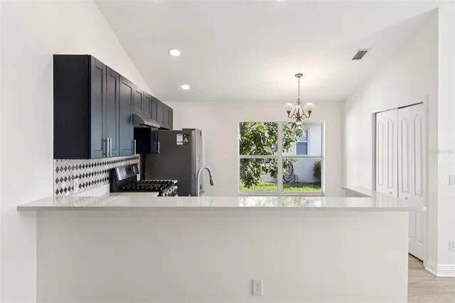 a view of a kitchen with a sink and a large window