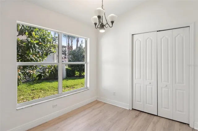 a view of a livingroom with a large window wooden floor and front door