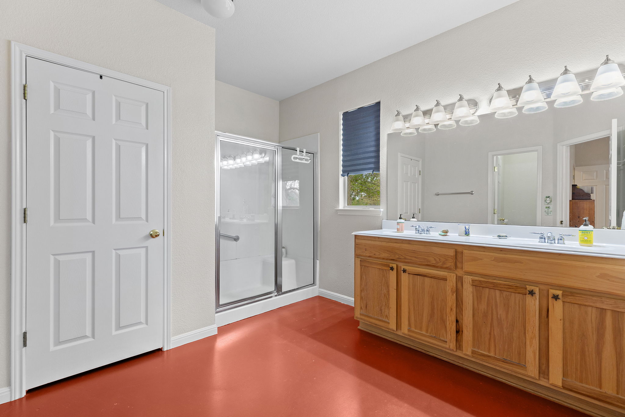 202 The Oaks Boulevard Elgin, TX 78621 - Photo 22 of 40 Full bath featuring a stall shower, double vanity, and concrete flooring