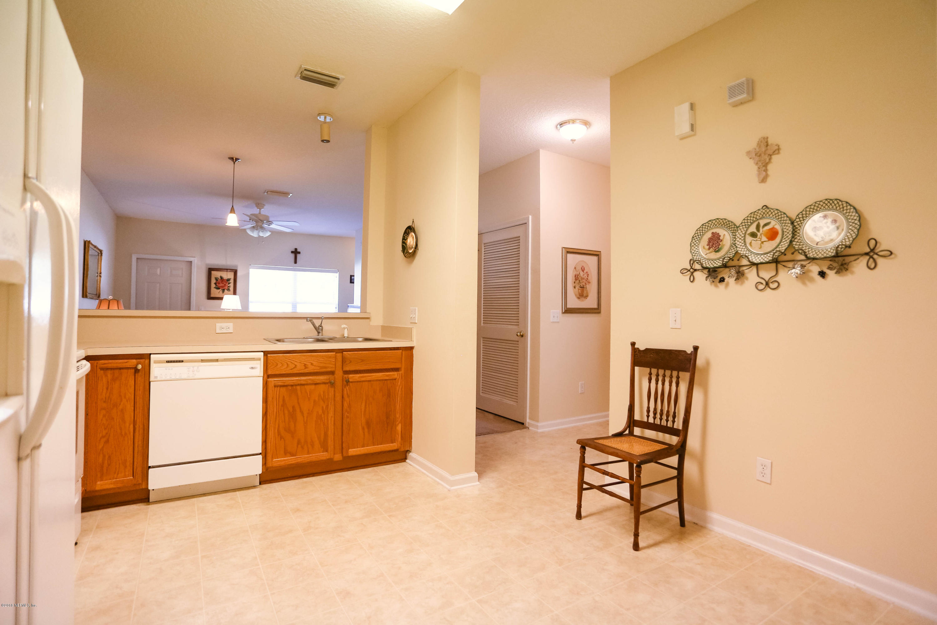 1205 Southern Stream Court Jacksonville, FL 32259 - Photo 13 of 42 a kitchen with a refrigerator and cabinets