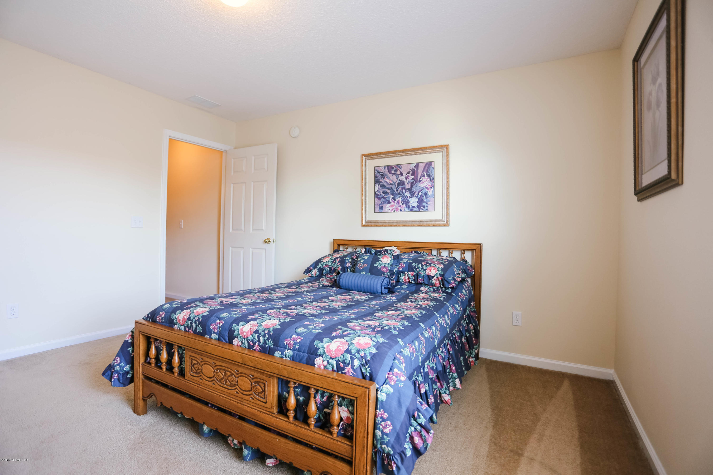 1205 Southern Stream Court Jacksonville, FL 32259 - Photo 17 of 42 a bed sitting in a bedroom next to a window