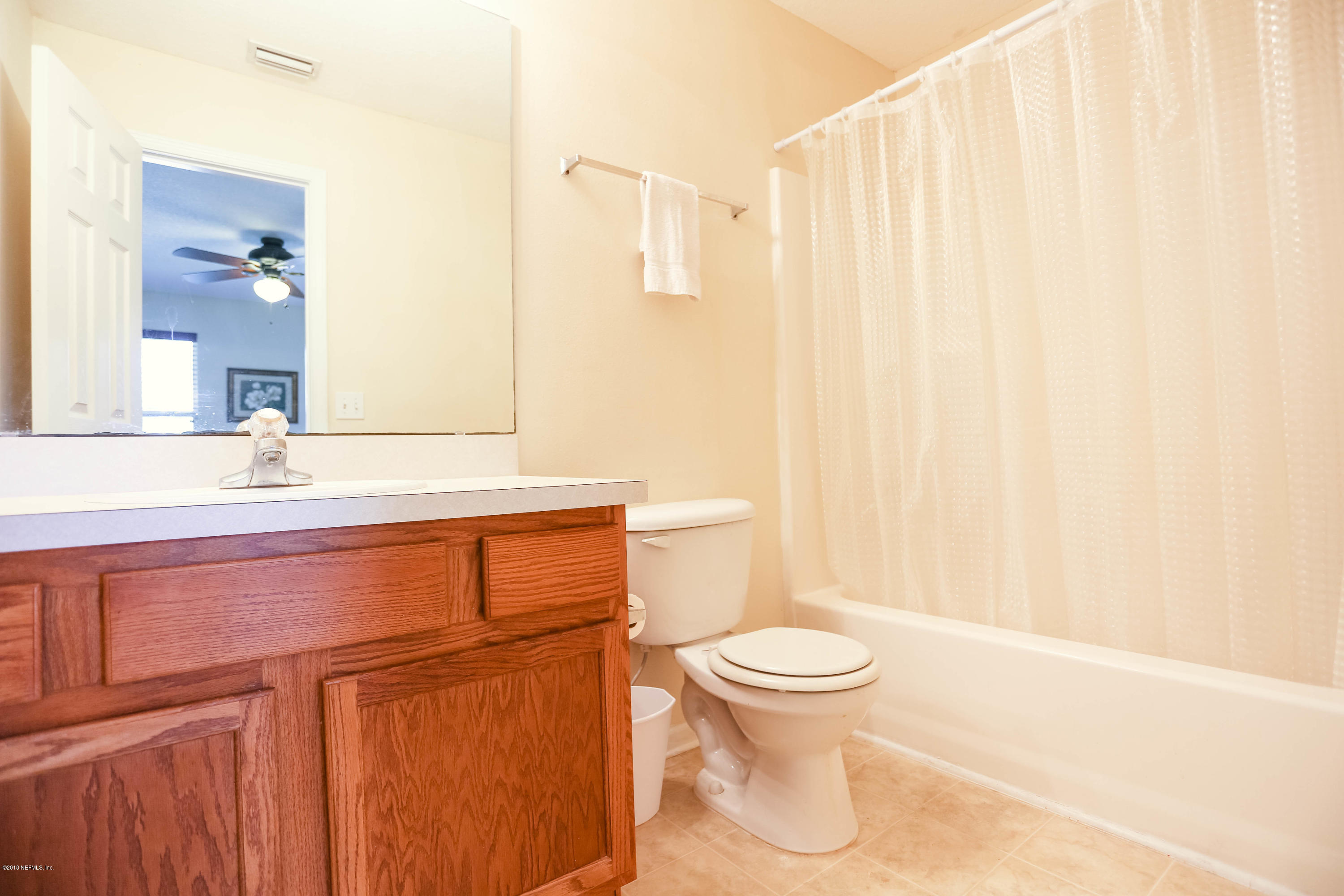 1205 Southern Stream Court Jacksonville, FL 32259 - Photo 19 of 42 a bathroom with a toilet a sink and a mirror